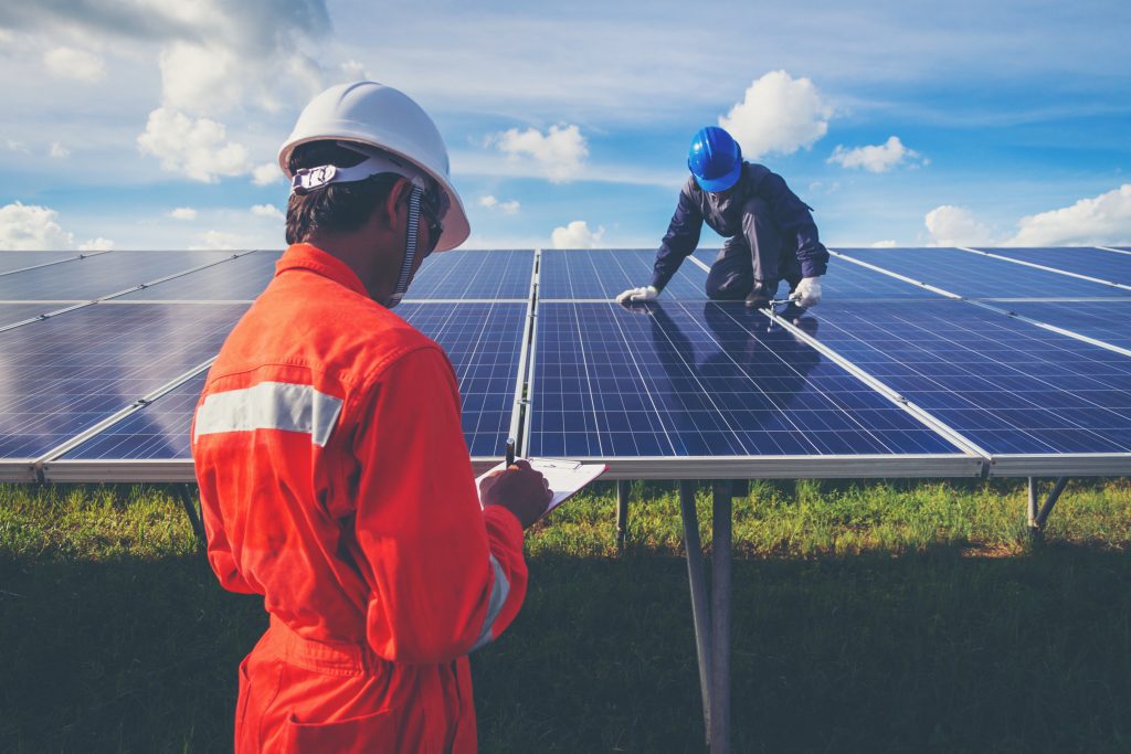 Man on solar panels installing in farm - Northmore Gordon